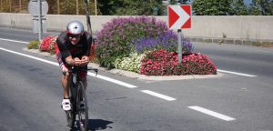 athlete biking on road
