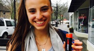 woman holding HOTSHOT at store front