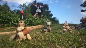 athlete jumping in background of HOTSHOT bottle