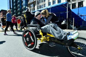 man and woman celebrate at the marathon finish line