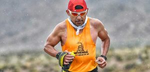 man in red hat running in the rain