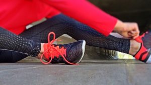 athlete putting on shoes before run