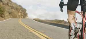 close up of cyclist legs while biking