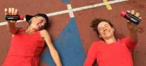 Two athletes smiling holding HOTSHOT