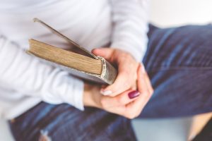 close up of woman holding a book