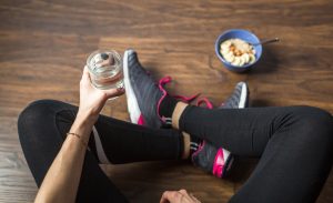 Fitness woman eating oatmeal porridge