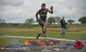 athlete during Spartan race jumping over fire