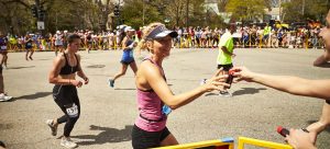 HOTSHOT team handing out sports shot to runners