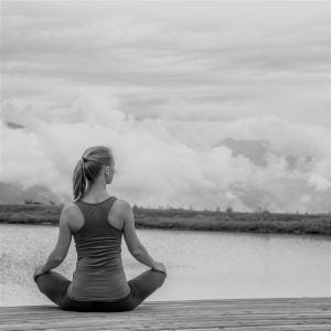 woman sitting in yoga pose outside