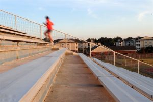 athlete running up bleachers