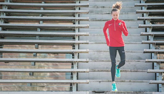 athlete running in bleachers