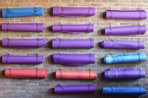a wall of yoga mats hanging