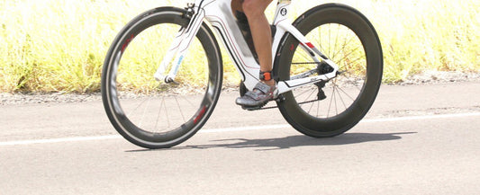 close up of cyclists legs during race