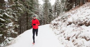 athlete running on a trail in the winter
