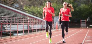 two athletes running on track